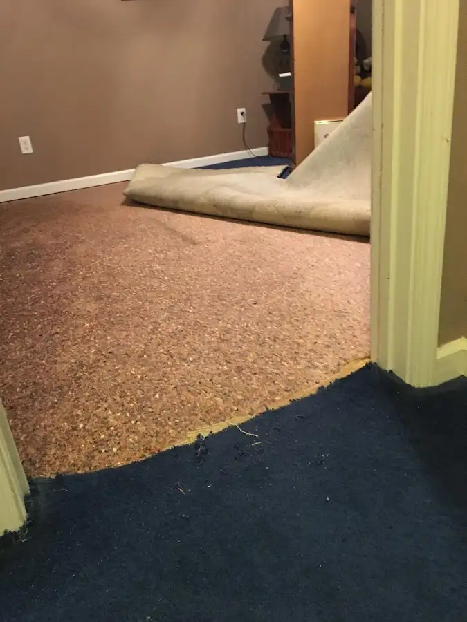 Carpet pad removal revealing water damage during Water Mitigation Services in Fairfield